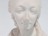 a white statue of a woman with braid hair