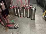 several kegs are lined up in a row in a kitchen