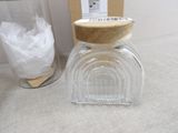 a glass jar with a wooden lid next to a glass jar with a wooden lid