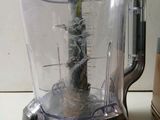 a blender that has a plant in it on the counter