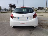 a small white car parked in a parking lot