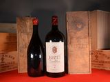 two bottles of wine sitting next to each other on a table