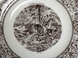 a brown and white plate with a picture of a man riding a horse