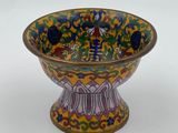 a yellow bowl with a bird design on it