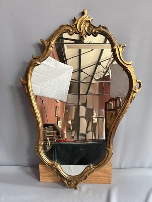 un miroir posé sur une table avec une feuille de papier
