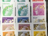 four different stamps of different colors and designs on a table