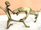 a statue of a man and a dog on a table