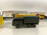 several toy trucks are lined up in a row on a white surface