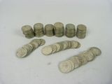a lot of coins sitting on a white surface