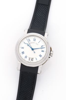 a close up of a watch on a white surface with a black strap