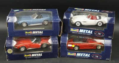 three toy cars are sitting in boxes on a black surface