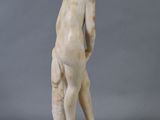 an image of a statue of a boy standing on a pedestal