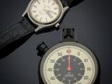 a watch and a wrist watch sitting next to each other