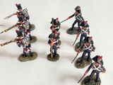 seven figurines of soldiers in uniform on a white surface