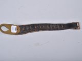 an image of a brown leather strap with a tag on it
