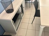 a table and chairs in a room with blue walls