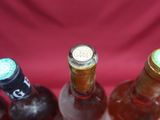 several bottles of wine are lined up in a row on a table