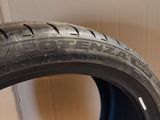 a close up of a tire on the ground next to a box