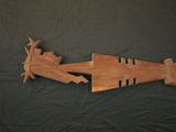 a wooden arrow that is laying on a black cloth