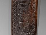 an old wooden plaque with a decorative design on it