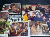 several old movie posters of men and women sitting on a couch