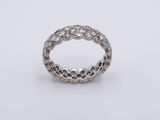 a close up of a silver ring on a white surface