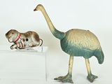 two figurines of a bird and a dog on a table