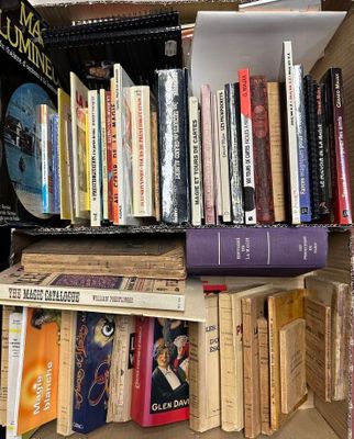 many books that are on a shelf in a box