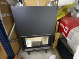 a black stove in the middle of a room next to boxes