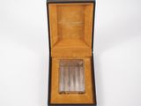 an open box with a cigarette in it on a white surface