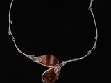 a close up of a necklace on a mannequin neck