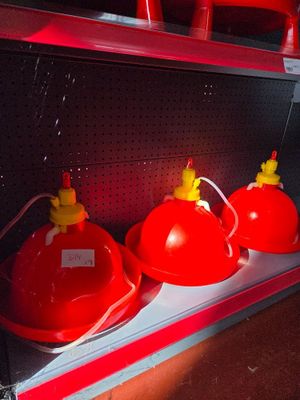 three red fire hydrants sitting on a shelf in a store