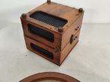 a small wooden box sitting on a table next to a mirror