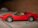 a red sports car parked in a garage with a brick wall
