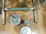 a table that has some cans on it on the floor