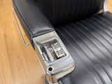 a black leather chair with a cell phone on it