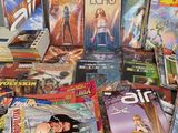 a lot of comic books that are on the table
