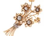 un gros plan d'une broche ornée de fleurs et de diamants
