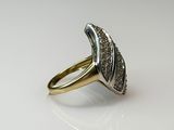 a close up of a gold ring with diamonds on a white surface