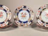 three plates with floral designs are sitting on top of each other