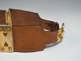 brown leather belt with brass buckle and rivets on a white surface