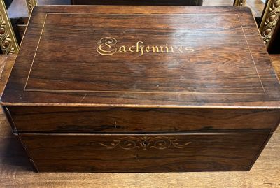 an old wooden box sitting on top of a table next to a mirror