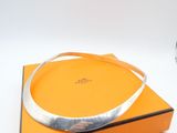 an orange box with a silver bracelet on top of it