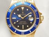 a gold wrist watch with a blue dial on it