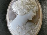 un gros plan du visage d'une femme dans un coquillage sculpté