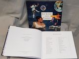 an open book with a picture of a woman and a car
