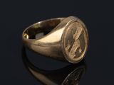 a gold signet ring with the initials of two men