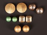 quelques ornements dorés et verts sont disposés sur une surface noire