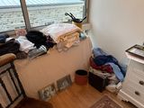 an image of a messy bedroom with clothes on the bed