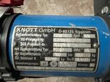 a close up of a blue motor bike with a red light on it